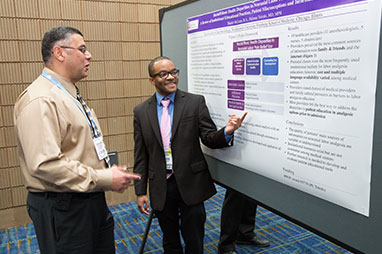 Photo of two men looking at a presentation. Link to Gifts That Pay You Income.