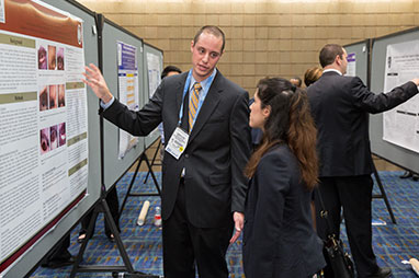 Photo of two people looking at a presentation. Link to Gifts of Appreciated Securities.