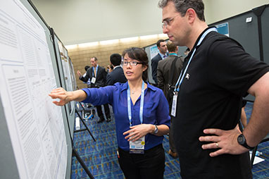 Photo of two people looking at a presentation. Link to What to Give.