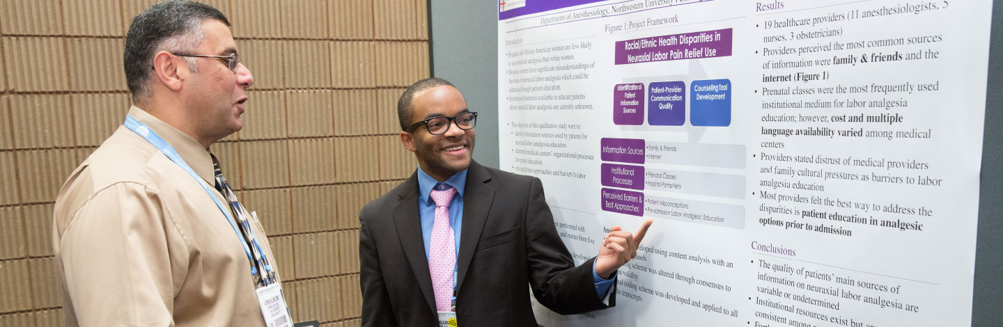 Photo of two men looking at a presentation